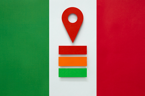 Red map pointer on the Italian Flag