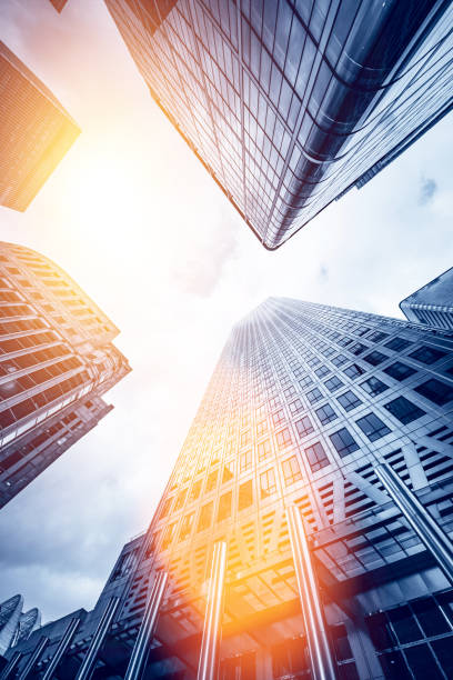 Looking directly up at the skyline of the financial district in Canary Wharf, London, United Kingdom - creative stock image stock photo