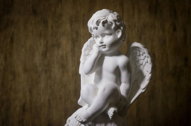 istock Beautiful white Angel on wooden background 1214707336