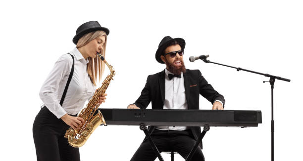 istock Woman playing a sax and a man playing keyboards 1214710838