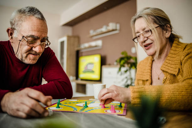 istock An older couple plays board games 1214711004