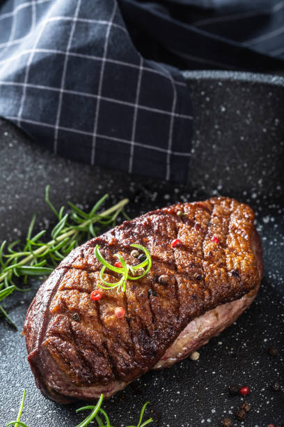 istock Duck breast roasted in ceramic pan with salt spices and rosemary 1214711917