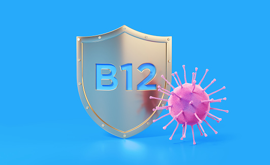 B12 vitamin written gold colored shield protecting from a virus on blue background, Horizontal composition with copy space. Health concept.