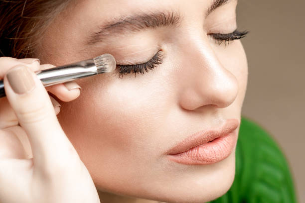 istock Makeup artist applies eyeshadow. 1214712934