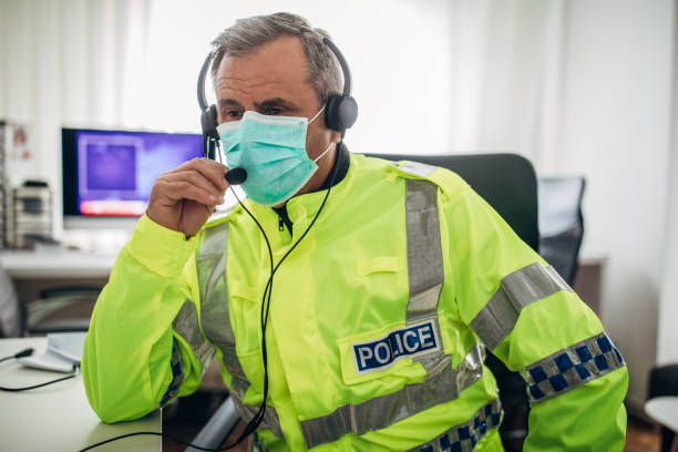 one senior british police officer with protective mask in the office - police power imagens e fotografias de stock