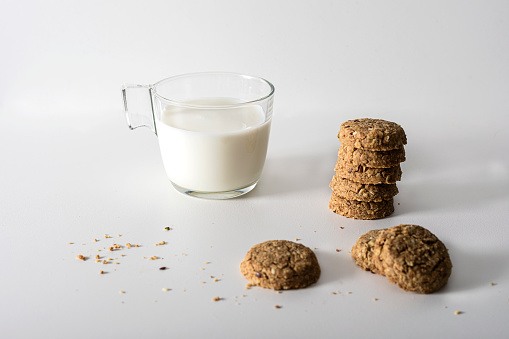 Glad of milk and cookies on white backgrounds