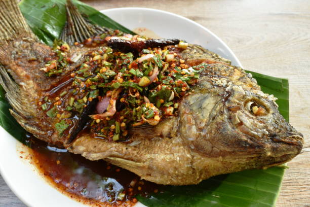 istock fried mango fish dressing spicy sauce and fresh vegetable 1214716439