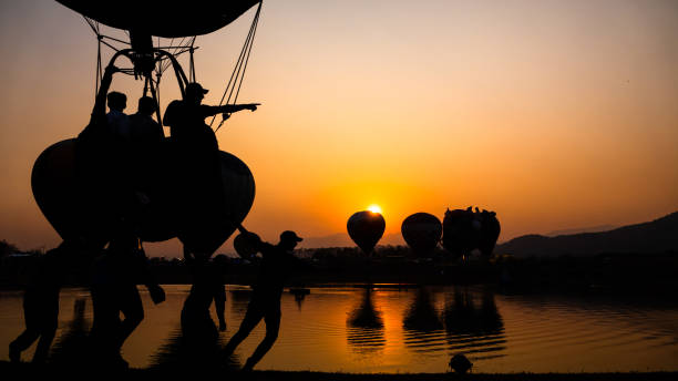 istock Hot air balloons glowing at sunset 1214718553