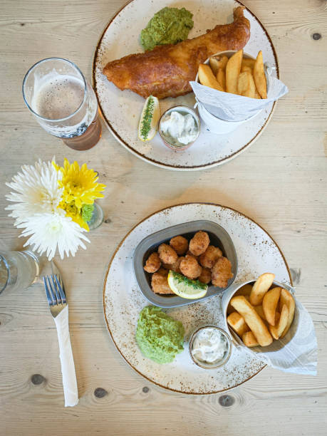 istock Overhead view of Fish and Chips and Scampi and chips. 1214719408