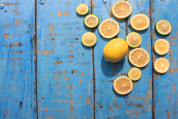 Lemon slices on a wooden background. Top view. Free space for text.