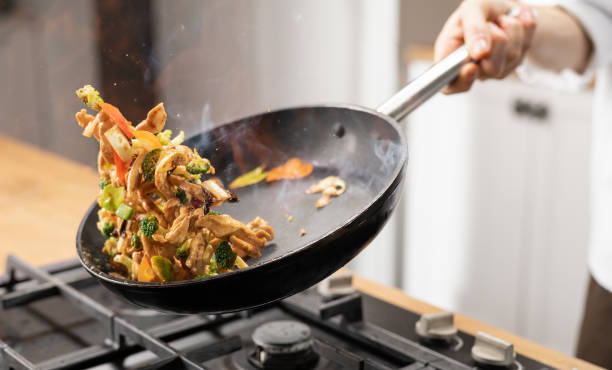 istock Professional Chef Tossing Food 1214723389