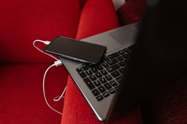 istock The smartphone is charging from the laptop 1214723676
