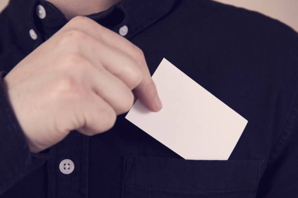 istock Young Man Takes Out Blank Business Card 1214725063