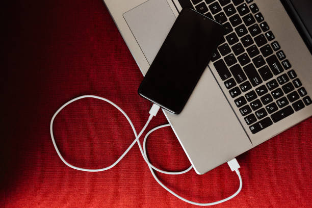 istock The smartphone is charging from the laptop 1214725138