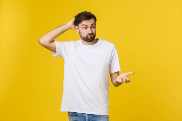 istock Worried young man standing isolate on yellow wall 1214725362