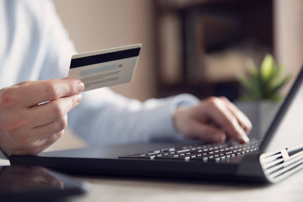 istock Man is Shopping Online with Credit Card 1214726525