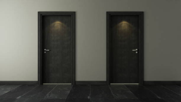 istock two black wooden door under spot light with wall and black stone floor 3D rendering 1214727150