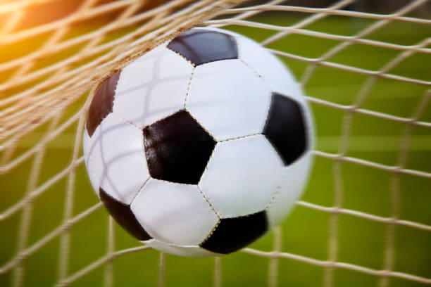 istock soccer ball in a net, motion bluer 1214727163