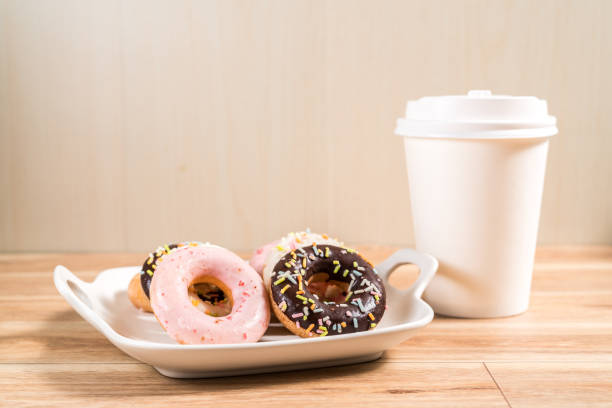 istock Donuts and coffee on wooden table. 1214727955