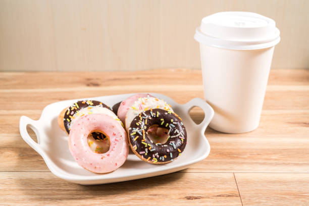istock Donuts and coffee on wooden table. 1214728142