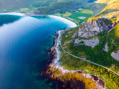 Coast of Vestvagoy island, Uttakleiv location. Seascape with scenic shoreline high mountains and sandy beach. Lofoten archipelago Northern Norway, Europe.