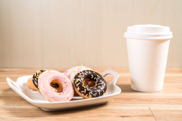 istock Donuts and coffee on wooden table. 1214728649