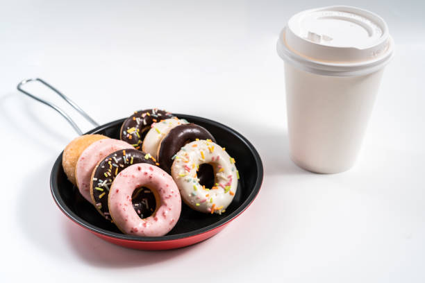 istock Donuts and drink and iron frying panon white background top view copy space pattern 1214728925