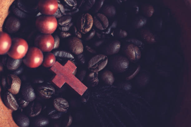 istock coffee beans and a wooden cross top view 1214730621