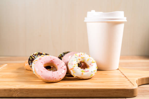 istock Donuts and coffee on wooden table. 1214730919