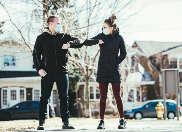 istock COVID-19, Young couple meeting outside 1214731085