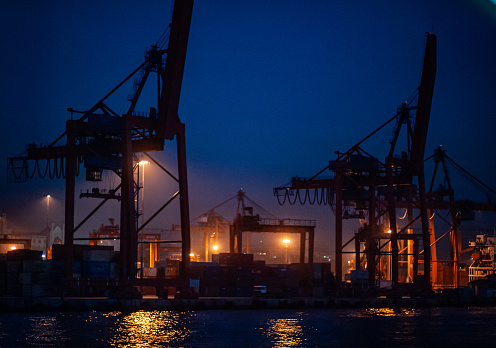 Container and cargo ship at night in Istanbul's Haydarpaşa Port, Turkey