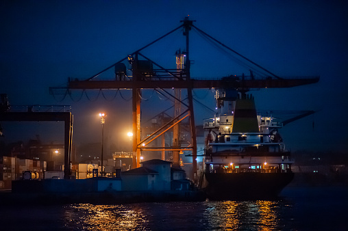 Container and cargo ship at night in Istanbul's Haydarpaşa Port, Turkey