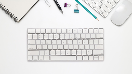 Top view office desk with computer and office supplies isolated on white background