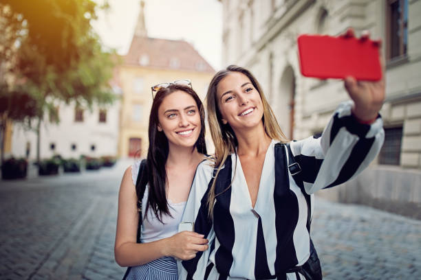 istock Girlfriends are taking selfie/making video call in a small town 1214737631