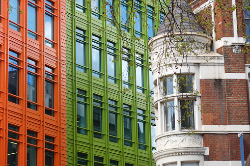 Modern city building architecture with glass fronts on a clear day in London, England