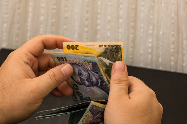 istock Man counting money, counting LEI close up 1214740215