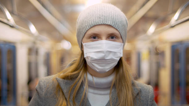 istock Female portrait in mask in subway 1214741277