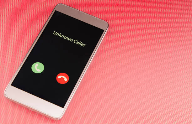 istock Unknown caller. White smartphone with incoming call from an unknown number on a red background. Incognito or anonymous 1214742337