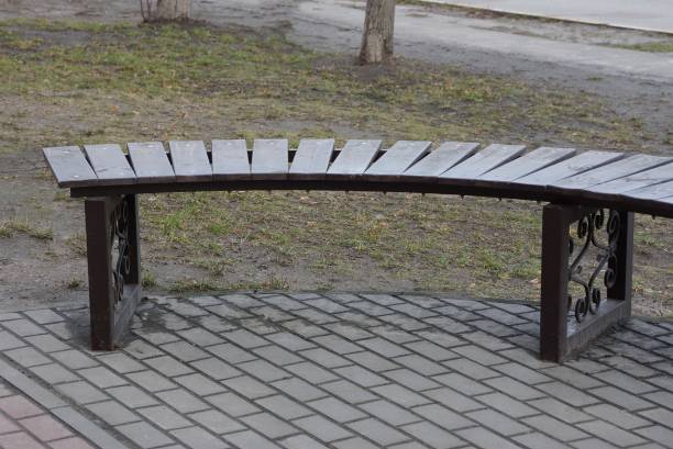 istock bench stands on a gray sidewalk 1214742854
