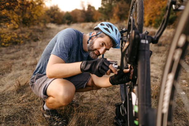 istock Mountain biker repairing broken bicycle 1214744128