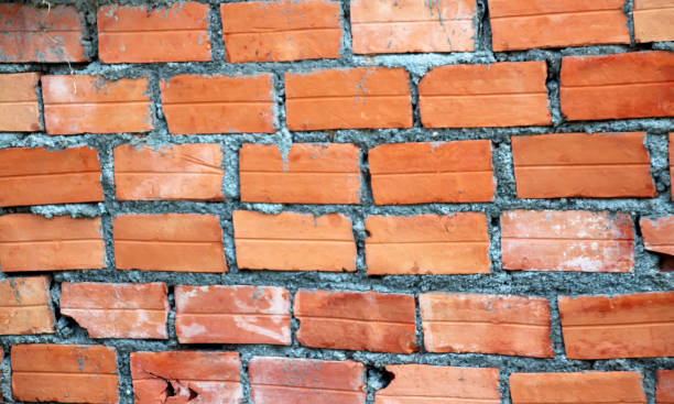 istock 1 Orange brick wall with layers of cement mortar 1214744582