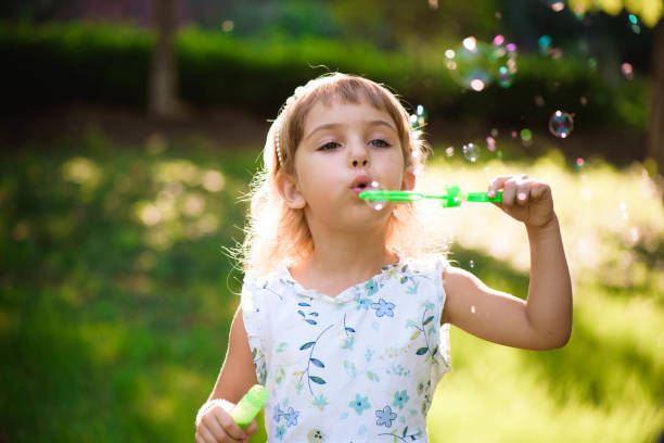 istock Girl with bubbles at a sunny summer evening 1214745969