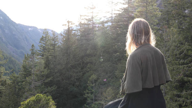 istock Young woman walks through forest 1214746226