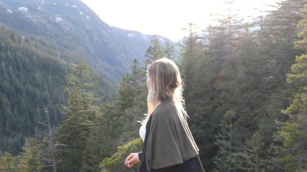 istock Young woman walks through forest 1214746232
