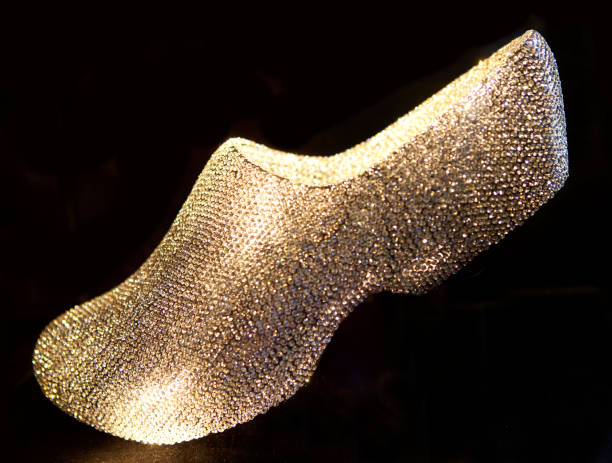 Typical Dutch wooden shoe in bling bling over black background