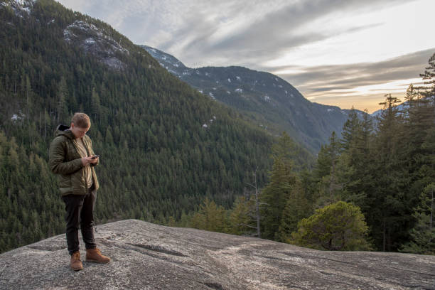 istock Young man relaxes on mountain ridge 1214746432