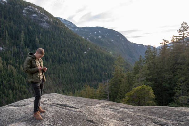 istock Young man relaxes on mountain ridge 1214746439