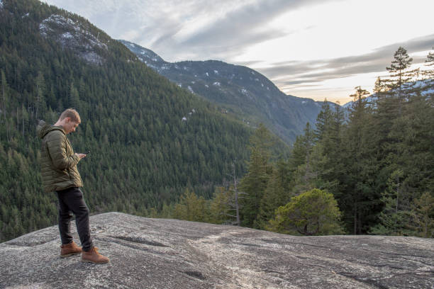 istock Young man relaxes on mountain ridge 1214746502