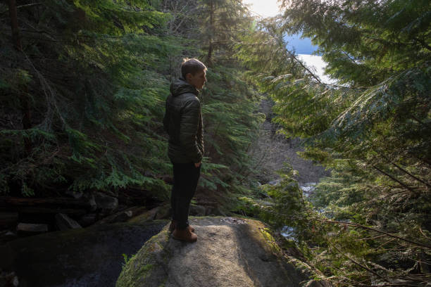 istock Young man relaxes in forest 1214746688