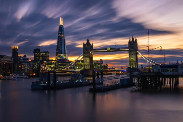 istock Illuminated London cityscape with Tower Bridge at sunset 1214747537